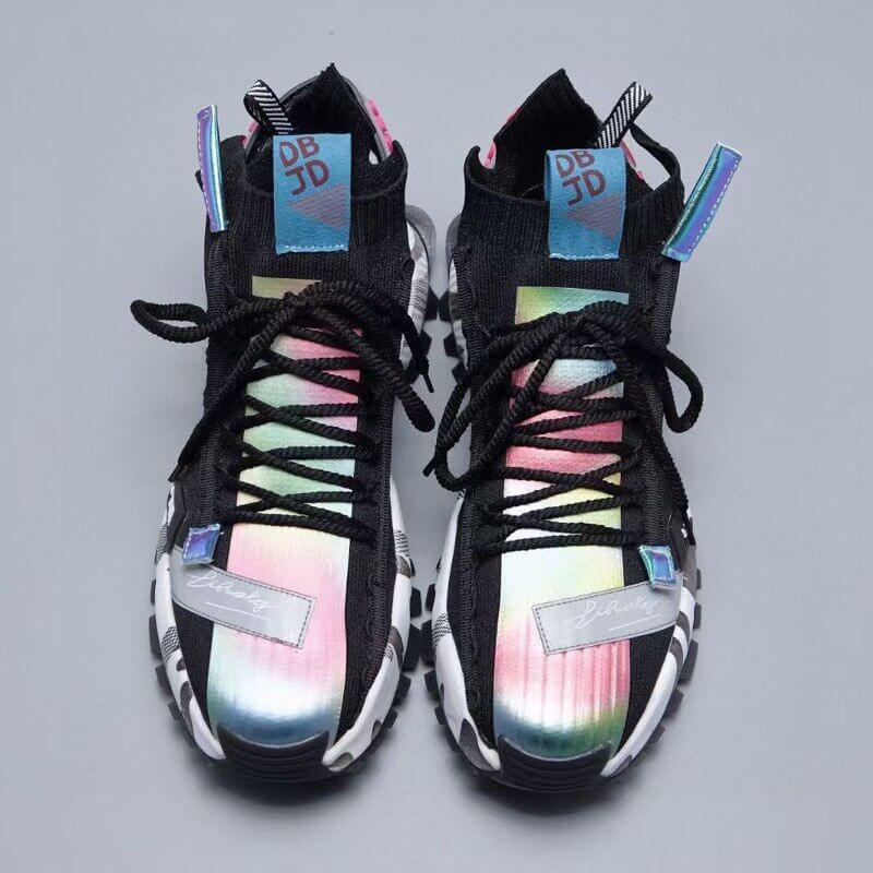 a pair of black and white sneakers with rainbow accents