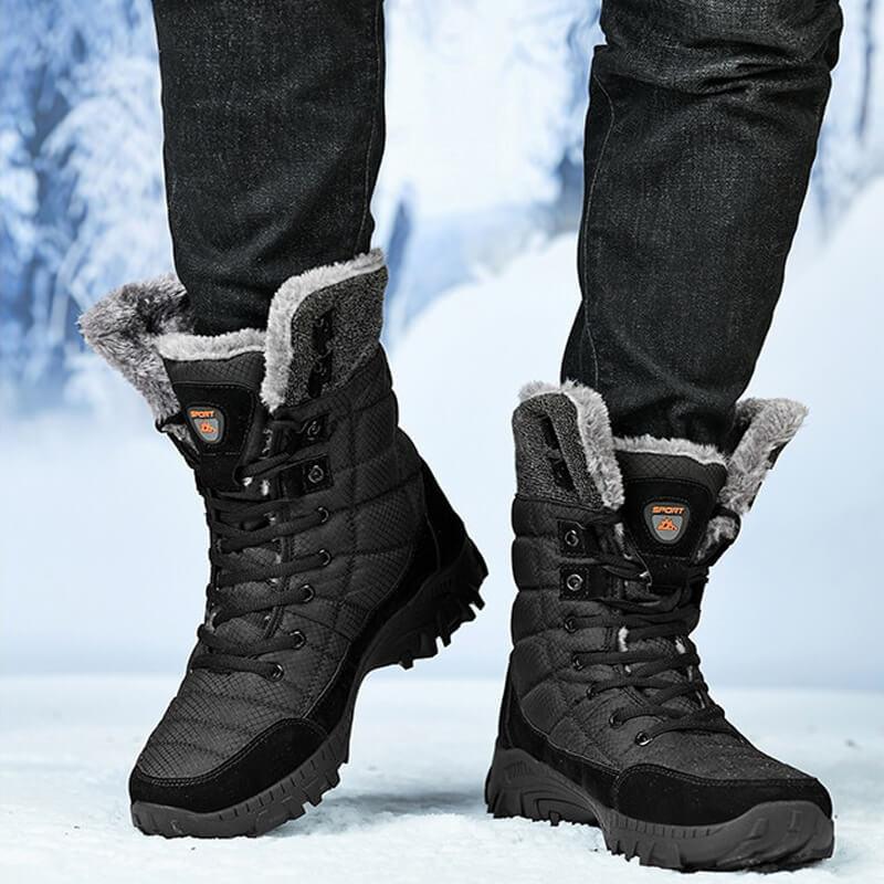 a person standing in the snow wearing winter boots