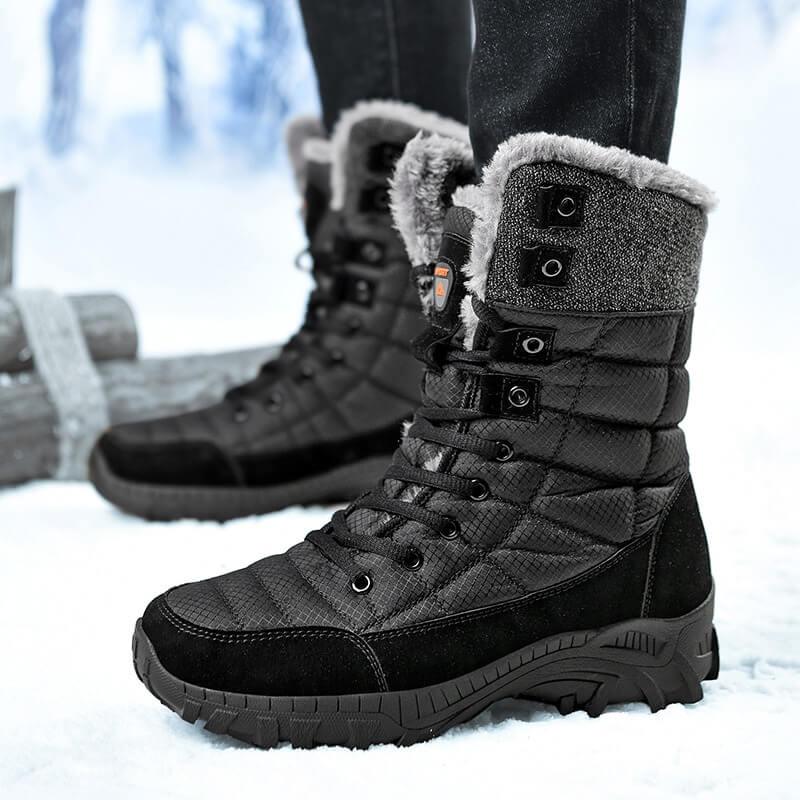 a person standing in the snow wearing winter boots