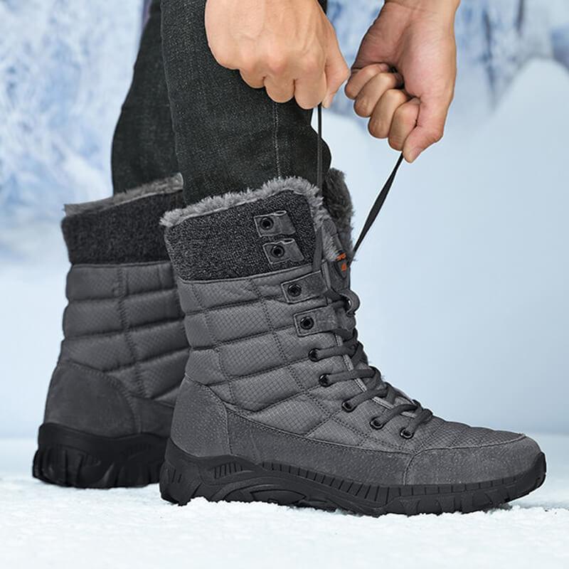 a person tying a pair of winter boots