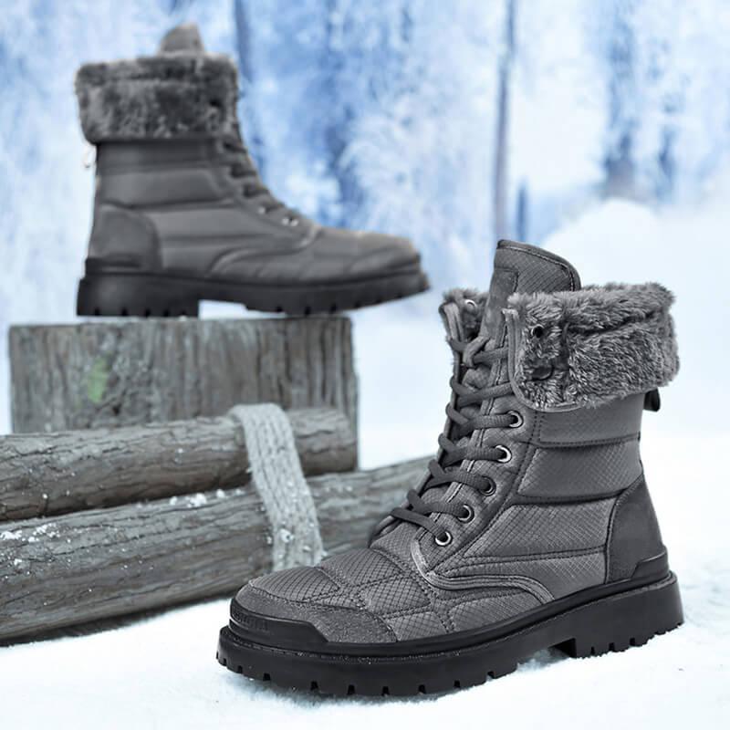 a pair of boots sitting on top of snow covered ground