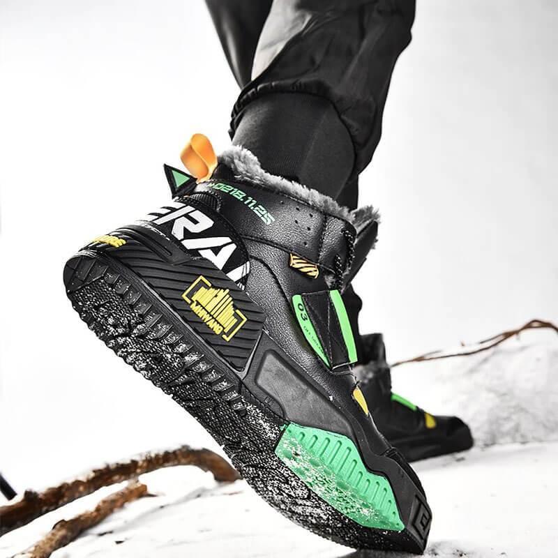 a person wearing black and green shoes on a snowy surface