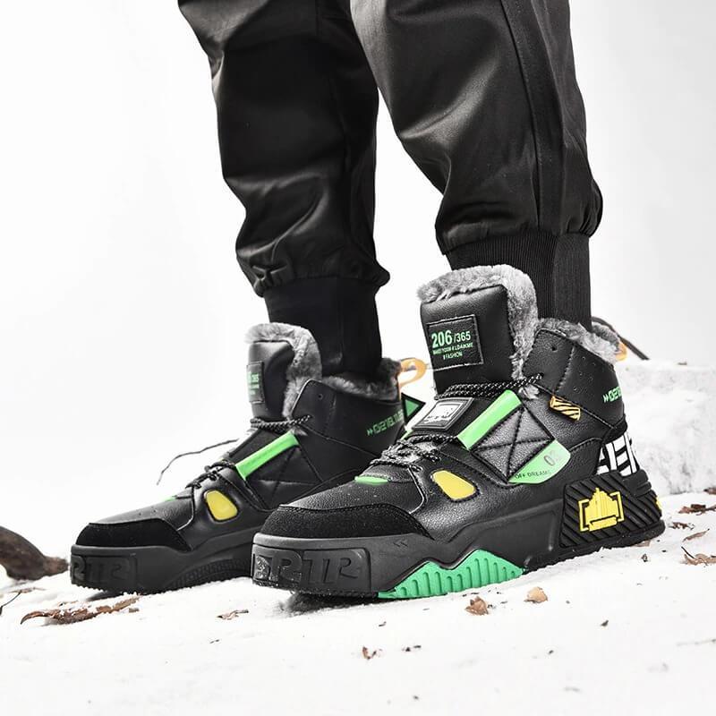 a pair of black and green sneakers on a snowy surface