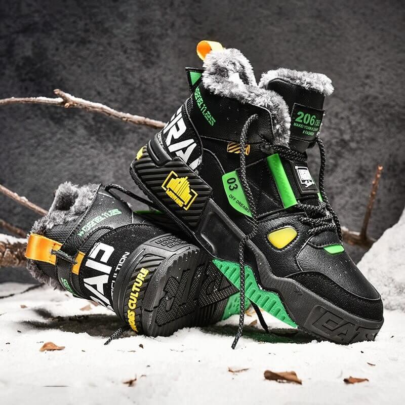 a pair of black and green snow boots