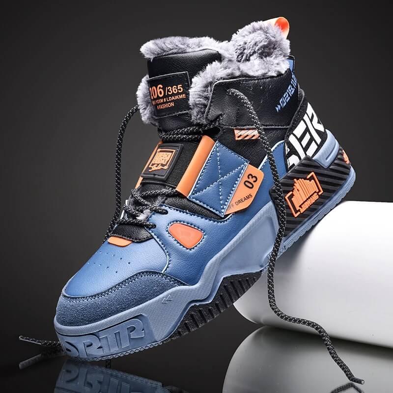 a pair of blue and orange sneakers on a black background