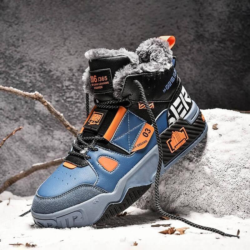 a pair of blue and orange sneakers on a rock