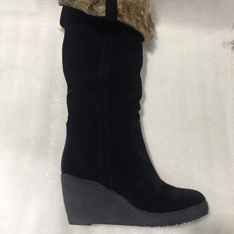 a pair of black boots with a fur lined heel